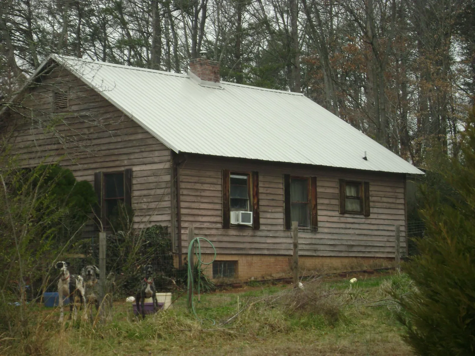 White metal roof on an old wood sided farmhouse, from a Metal Roof Installation job in Great Neck